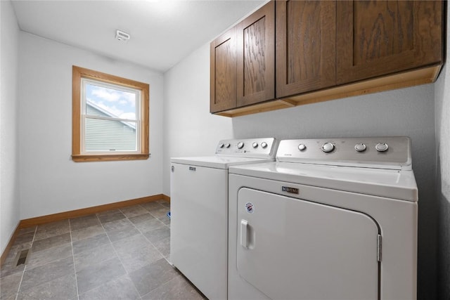 laundry room with cabinet space, stone finish floor, visible vents, baseboards, and independent washer and dryer