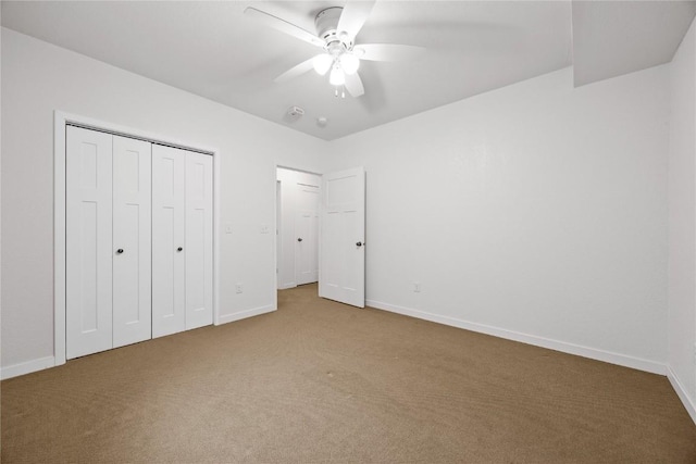 unfurnished bedroom featuring baseboards, a closet, and carpet
