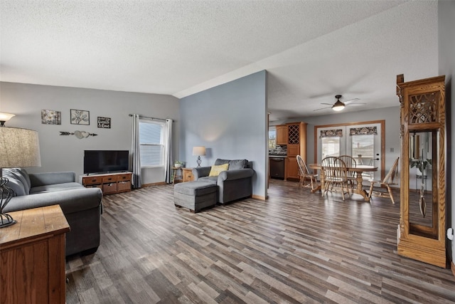 living room featuring a healthy amount of sunlight, ceiling fan, a textured ceiling, and wood finished floors