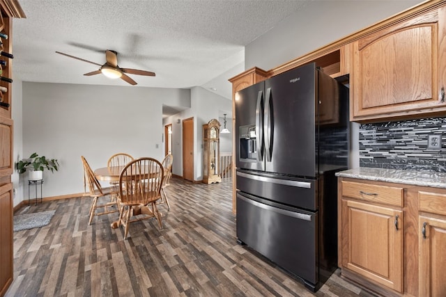 kitchen with a ceiling fan, a textured ceiling, dark wood-style flooring, tasteful backsplash, and black refrigerator with ice dispenser