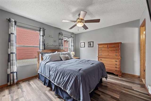bedroom with a textured ceiling and wood finished floors