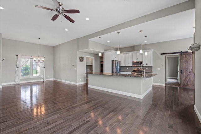 4332 Quail Trail Dr, Marion, IA 52302 - kitchen with appliances with stainless steel finishes, a barn door, a ceiling fan, dark wood-style floors, and recessed lighting
