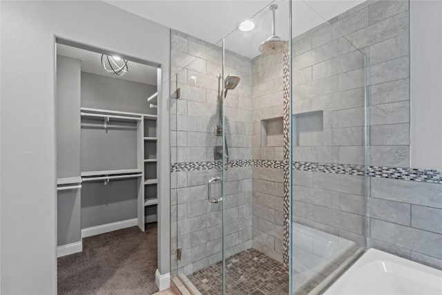 4332 Quail Trail Dr, Marion, IA 52302 - bathroom with a stall shower, a walk in closet, baseboards, and a bath