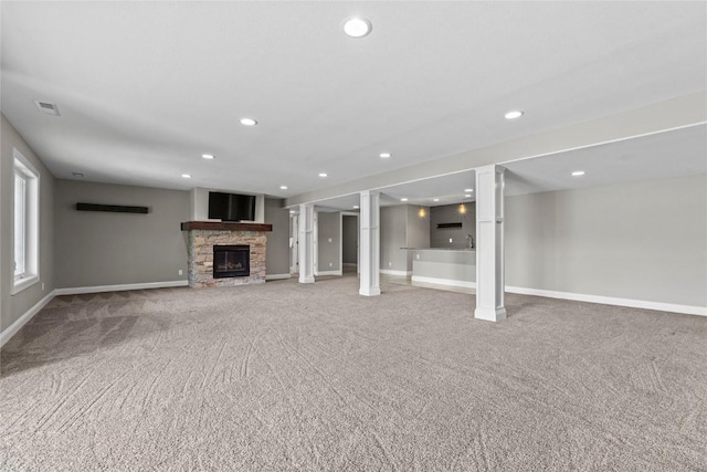4332 Quail Trail Dr, Marion, IA 52302 - below grade area with light colored carpet, a stone fireplace, recessed lighting, and baseboards