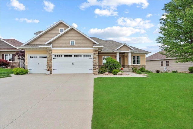 4332 Quail Trail Dr, Marion, IA 52302 - craftsman-style house with stone siding, a front lawn, concrete driveway, and a garage