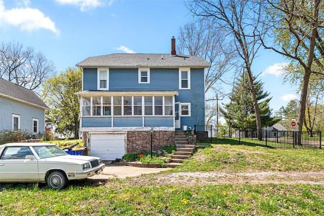 rear view of property with fence, stairs, a garage, a chimney, and a sunroom