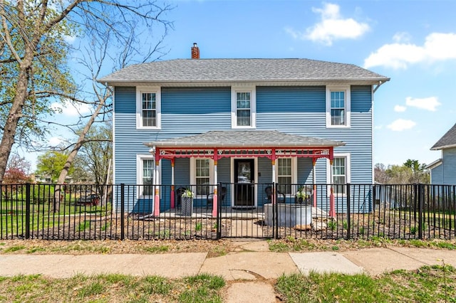 133 N 5th St, West Branch, IA 52358 - view of front of property featuring covered porch, a chimney, and a fenced front yard