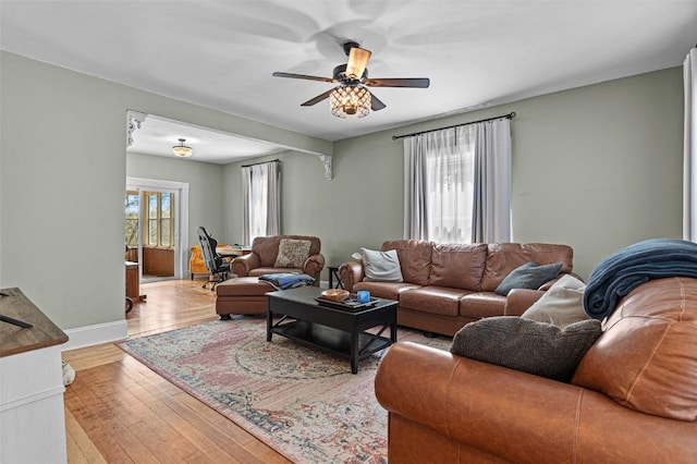 133 N 5th St, West Branch, IA 52358 - living area featuring ceiling fan, light wood-style floors, and baseboards