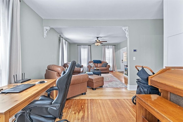 133 N 5th St, West Branch, IA 52358 - living area featuring a desk, wood finished floors, and baseboards