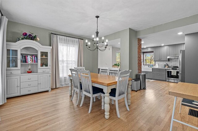 133 N 5th St, West Branch, IA 52358 - dining area with a chandelier and light wood-style flooring