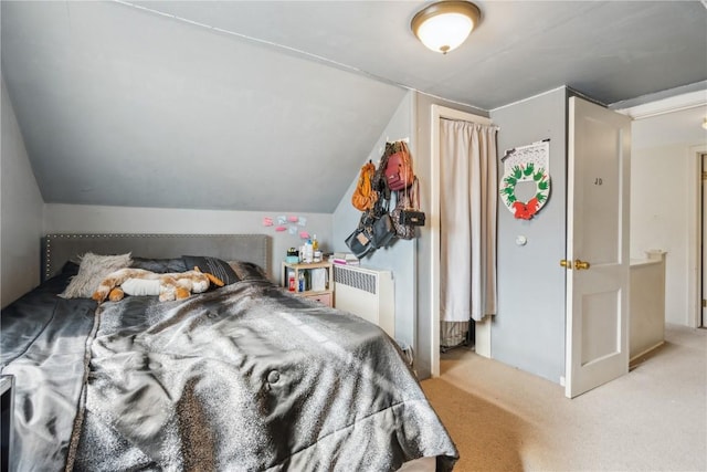 bedroom featuring radiator, light carpet, and vaulted ceiling