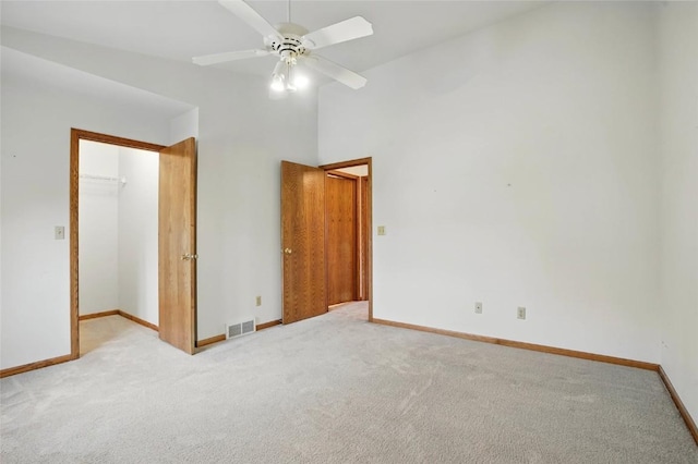unfurnished bedroom with light carpet, baseboards, a closet, and visible vents