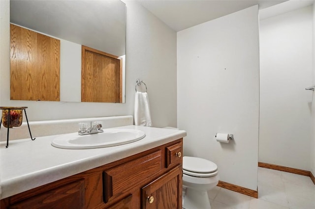 bathroom featuring baseboards, tile patterned flooring, vanity, and toilet