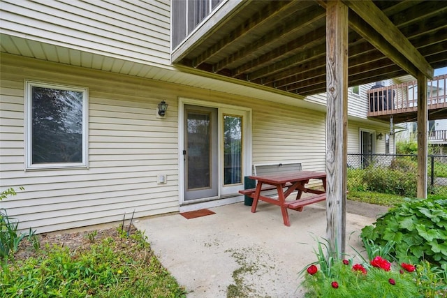 view of patio with outdoor dining area and fence