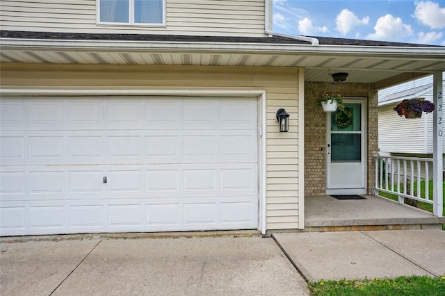 garage featuring concrete driveway