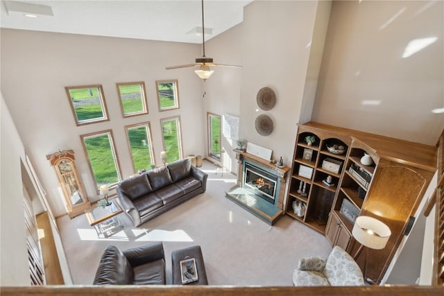 4199 Brookside Dr, Marion, IA 52302 - carpeted living area with a ceiling fan, high vaulted ceiling, and a glass covered fireplace