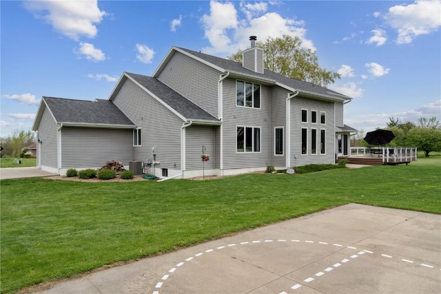 4199 Brookside Dr, Marion, IA 52302 - back of house with a wooden deck, cooling unit, a chimney, and a lawn