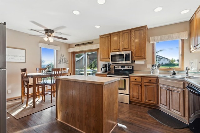 4199 Brookside Dr, Marion, IA 52302 - kitchen with a wealth of natural light, stainless steel appliances, a ceiling fan, and dark wood-type flooring