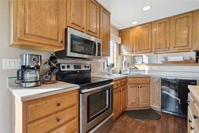 4199 Brookside Dr, Marion, IA 52302 - kitchen featuring brown cabinets, a sink, stainless steel appliances, light countertops, and dark wood-style floors