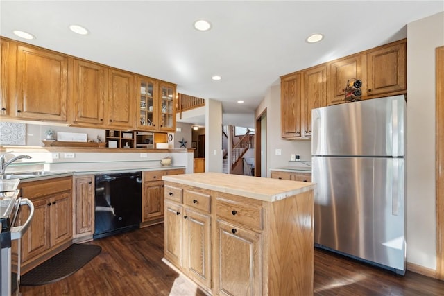 4199 Brookside Dr, Marion, IA 52302 - kitchen with glass insert cabinets, a sink, stainless steel appliances, dark wood finished floors, and light countertops
