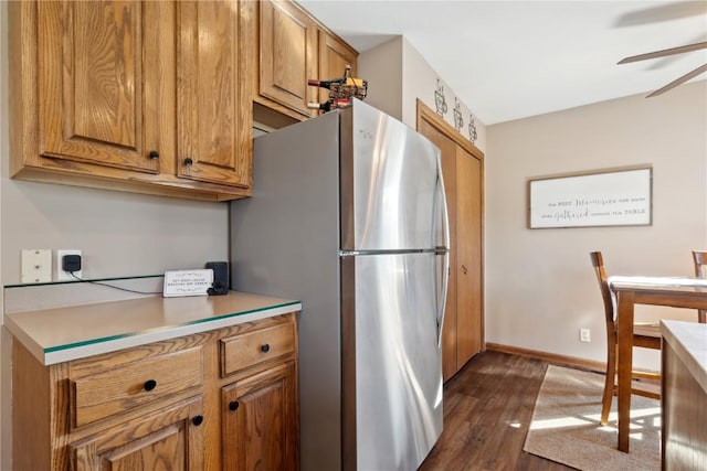 4199 Brookside Dr, Marion, IA 52302 - kitchen featuring freestanding refrigerator, dark wood finished floors, brown cabinets, and a ceiling fan