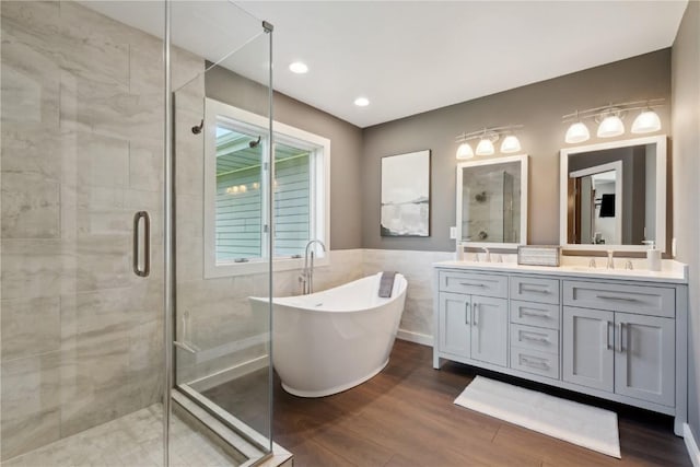 4199 Brookside Dr, Marion, IA 52302 - full bathroom featuring a shower stall, a soaking tub, double vanity, and wood finished floors