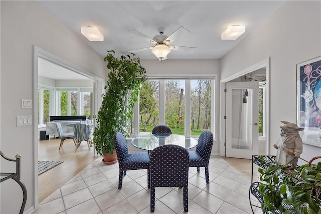 dining room with a ceiling fan and light tile patterned flooring