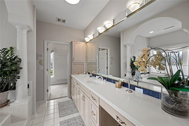 bathroom with decorative columns, vanity, visible vents, tile patterned floors, and baseboards