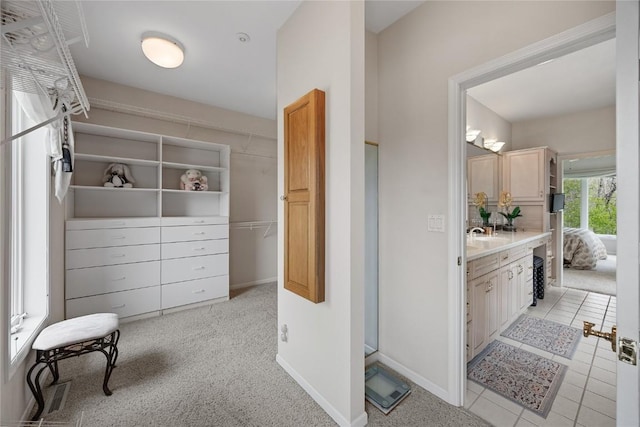 bathroom featuring a stall shower, tile patterned floors, visible vents, baseboards, and vanity