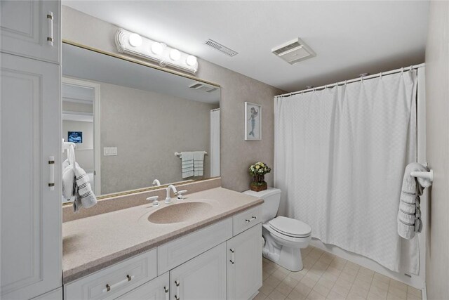 full bathroom with toilet, vanity, and visible vents