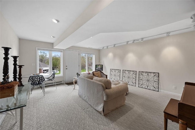 living room featuring light carpet, baseboards, and track lighting
