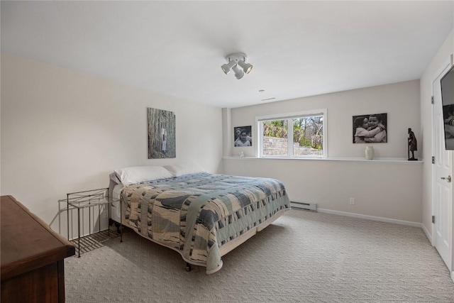 bedroom featuring a baseboard heating unit, baseboards, and carpet