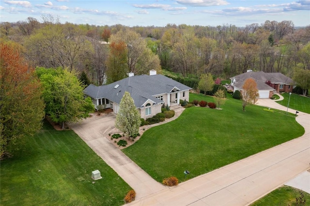 drone / aerial view featuring a forest view