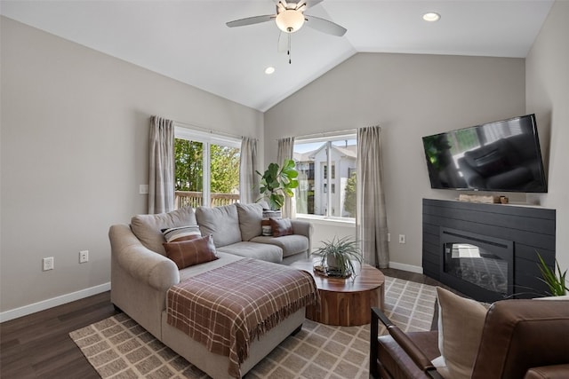 living room with wood finished floors, recessed lighting, a ceiling fan, baseboards, and a glass covered fireplace