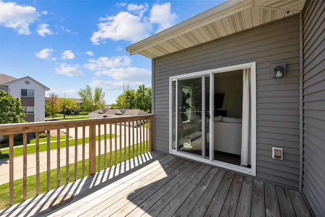 wooden terrace featuring a yard