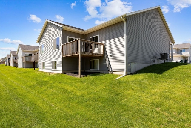 rear view of house with a deck, central AC, and a lawn