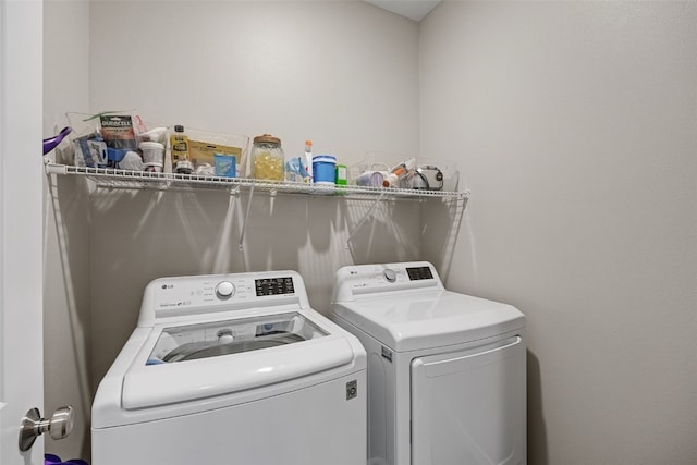 washroom with laundry area and separate washer and dryer