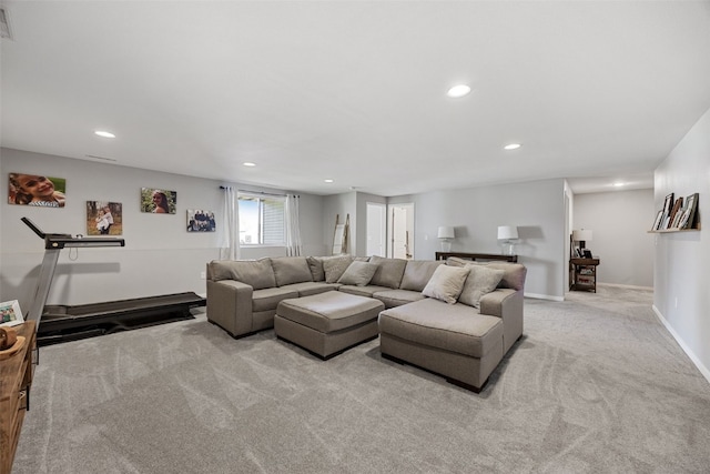 carpeted living area featuring baseboards and recessed lighting