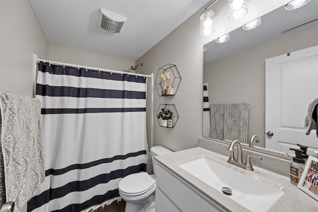 bathroom featuring toilet, visible vents, vanity, and a shower with shower curtain