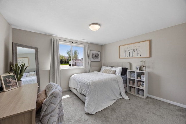 carpeted bedroom featuring baseboards