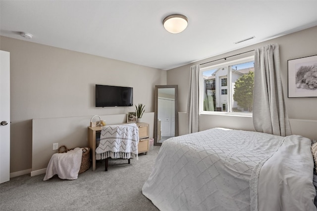 bedroom with visible vents and carpet