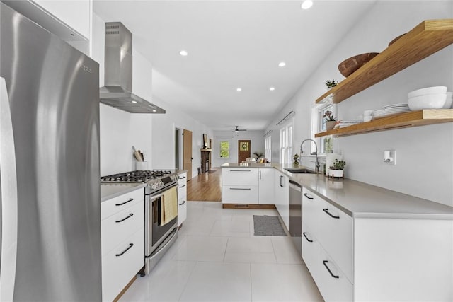 kitchen featuring a sink, stainless steel appliances, recessed lighting, and wall chimney exhaust hood