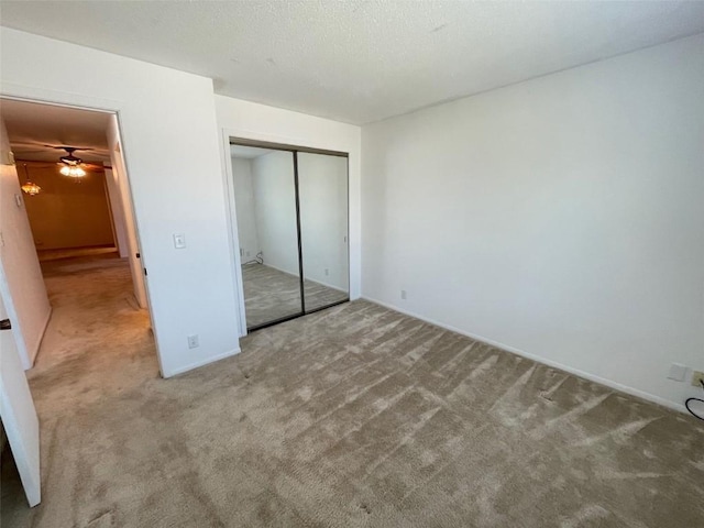 unfurnished bedroom with a closet, baseboards, and carpet floors