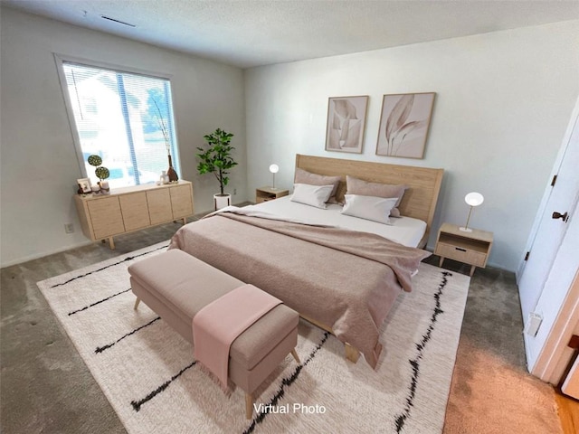 bedroom featuring a textured ceiling, carpet flooring, and visible vents