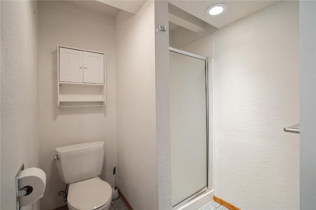full bath featuring toilet, a stall shower, and a textured wall