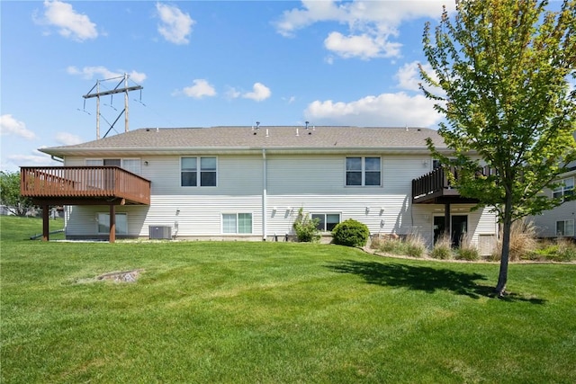 back of property featuring central air condition unit, a yard, and a deck