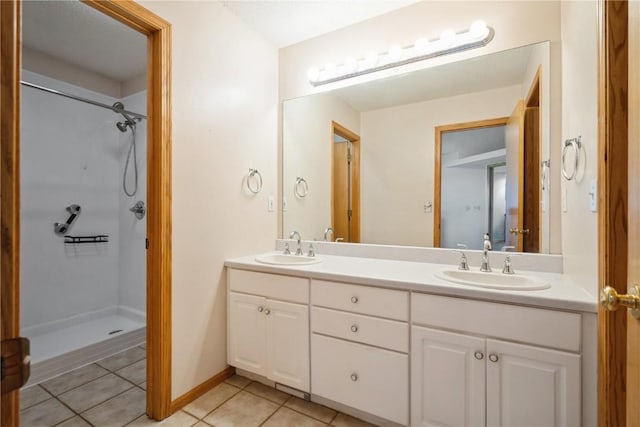 full bathroom featuring walk in shower, tile patterned floors, double vanity, and a sink
