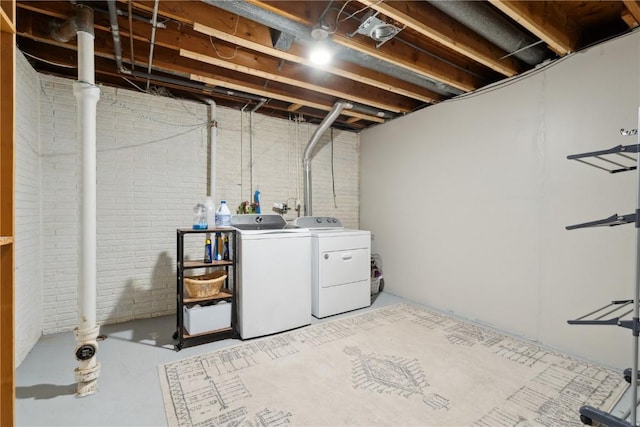 335 Parkland Dr SE, Cedar Rapids, IA 52403 - laundry area with brick wall, laundry area, and separate washer and dryer