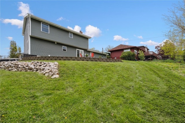 335 Parkland Dr SE, Cedar Rapids, IA 52403 - rear view of property with a yard, a chimney, and fence