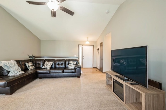 carpeted living area featuring vaulted ceiling and ceiling fan